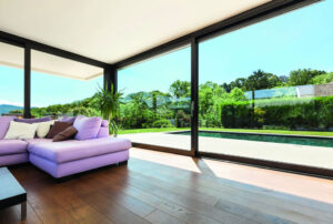 European lift and slide doors in a living room with a view of a pool